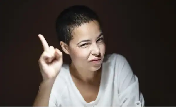 気をつけてとサインを送る人